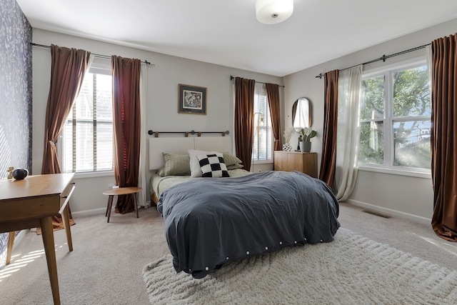 carpeted bedroom with multiple windows