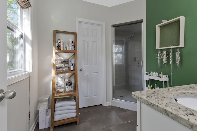 bathroom with an enclosed shower, tile patterned floors, vanity, and a healthy amount of sunlight