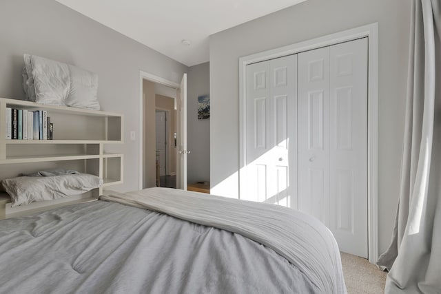 bedroom featuring a closet and light colored carpet