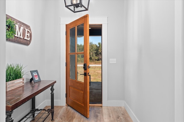 entrance foyer with a chandelier and light hardwood / wood-style flooring