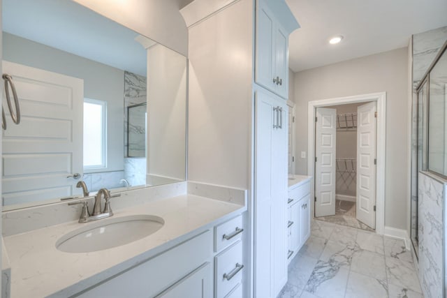 bathroom featuring vanity and a shower with shower door