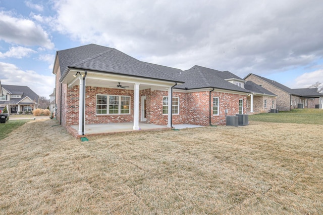 rear view of house with a lawn, a patio, and ceiling fan