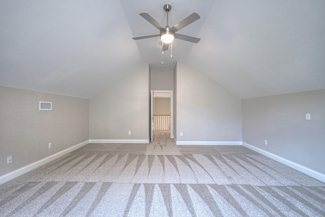 bonus room with lofted ceiling, light colored carpet, and ceiling fan