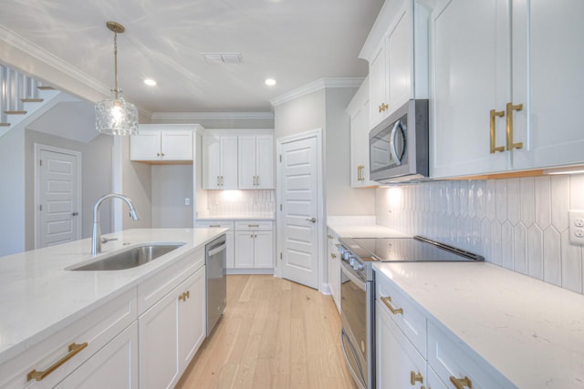 kitchen with sink, white cabinets, and appliances with stainless steel finishes