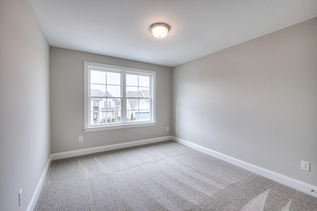 spare room featuring light colored carpet