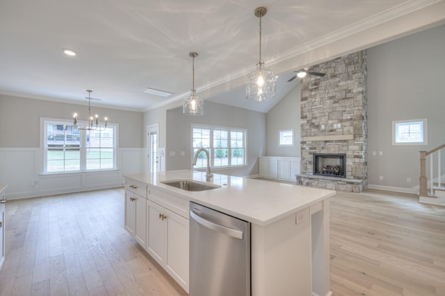 kitchen with lofted ceiling, sink, dishwasher, a kitchen island with sink, and white cabinets