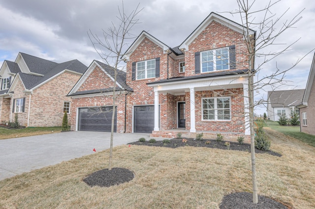 view of front of property featuring a garage, covered porch, and a front lawn