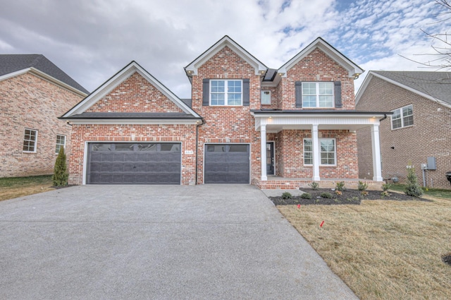 view of front of property featuring a porch, a garage, and a front lawn