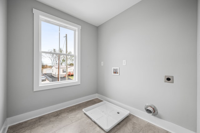 clothes washing area featuring electric dryer hookup, washer hookup, a healthy amount of sunlight, and light tile patterned floors