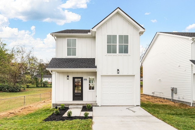 modern farmhouse featuring a front yard and a garage