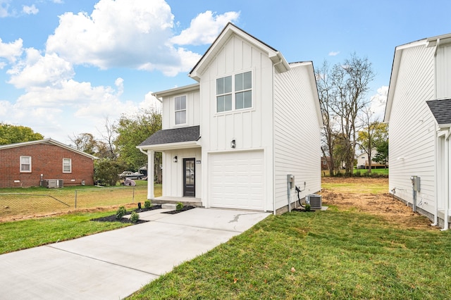 view of front facade featuring a front lawn, central AC, and a garage