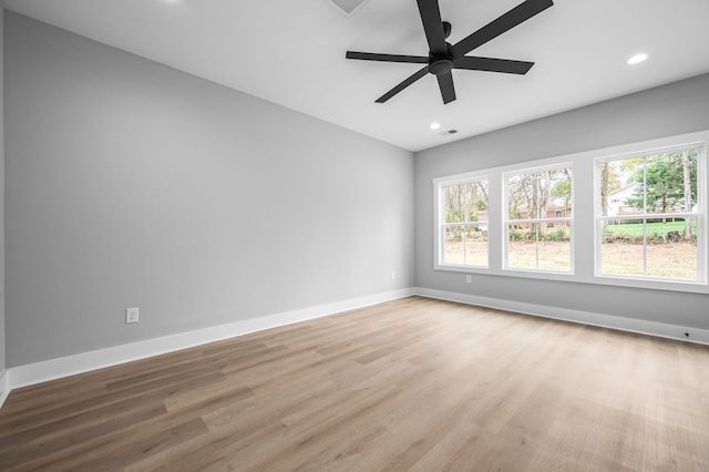 unfurnished room with light wood-type flooring and ceiling fan