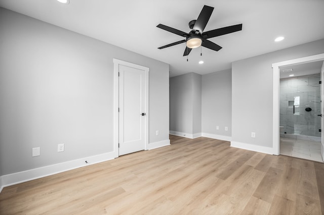 unfurnished bedroom with ensuite bathroom, light hardwood / wood-style flooring, and ceiling fan