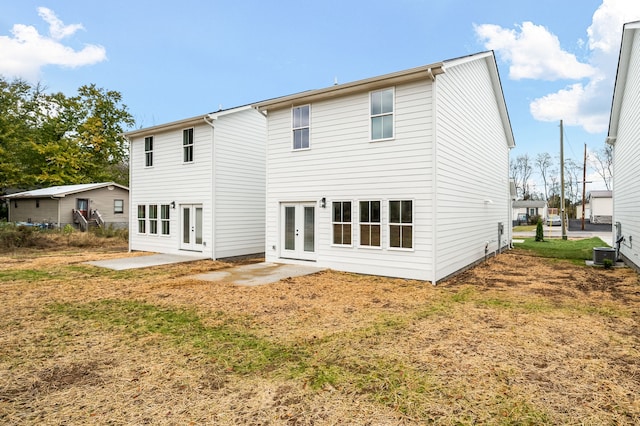 rear view of property with cooling unit and a patio area