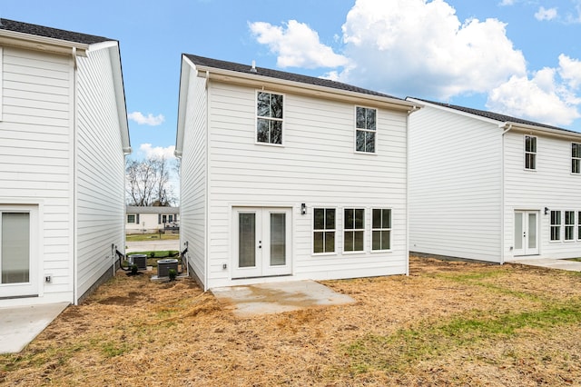 rear view of property with a patio area, french doors, and central air condition unit