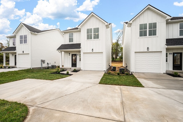 view of front of property featuring a garage and central AC unit