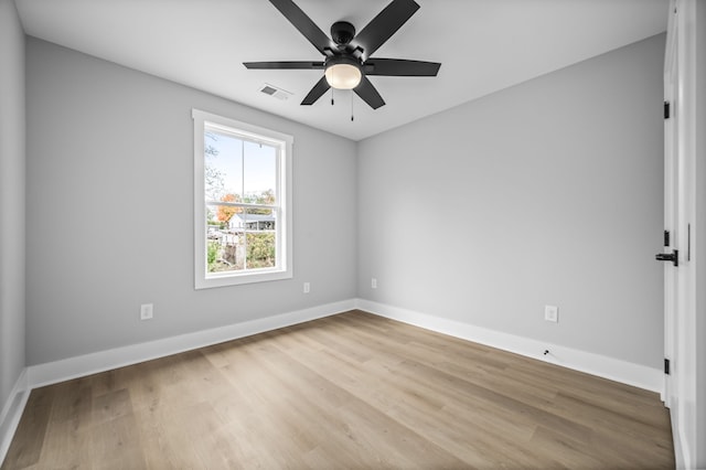 unfurnished room with hardwood / wood-style flooring and ceiling fan