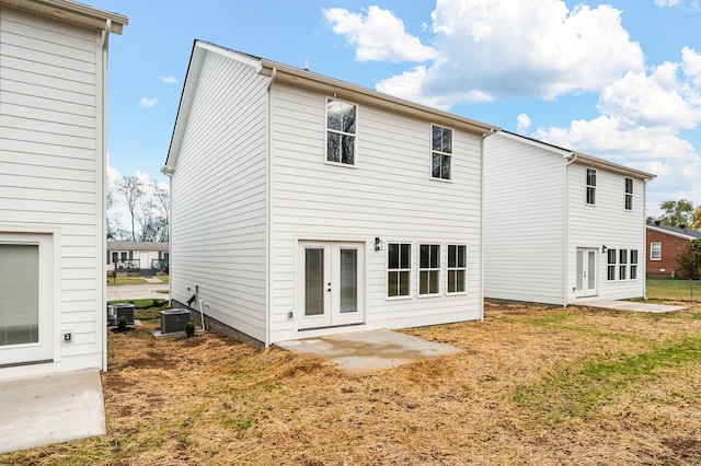 back of property featuring central air condition unit and a patio