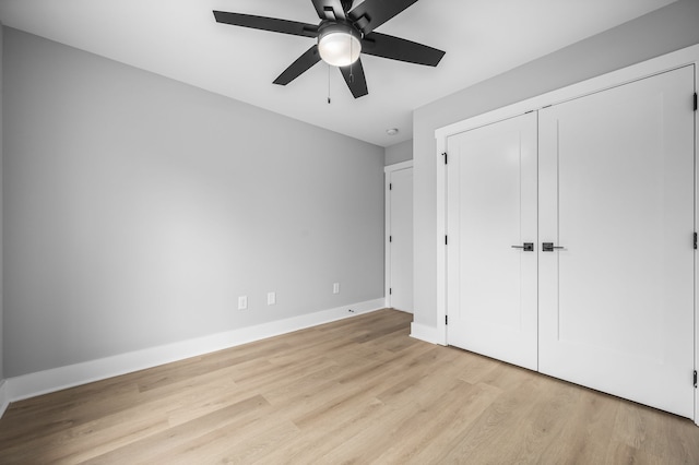 unfurnished bedroom with light hardwood / wood-style floors, a closet, and ceiling fan