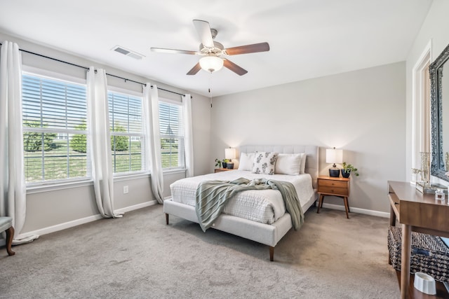 bedroom with ceiling fan and light colored carpet