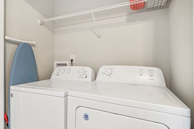 clothes washing area with washing machine and clothes dryer