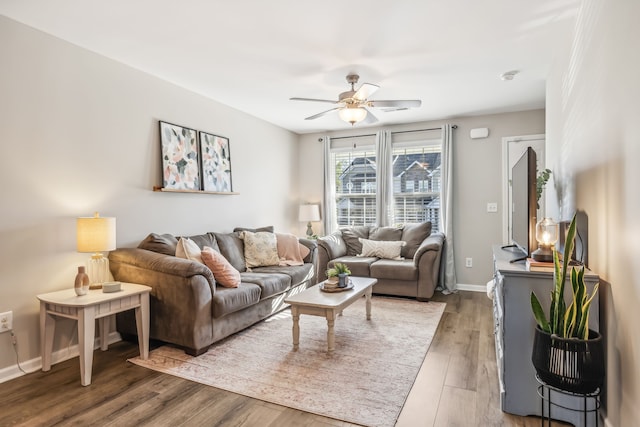 living room featuring ceiling fan and hardwood / wood-style floors