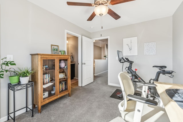 exercise area featuring ceiling fan and carpet flooring