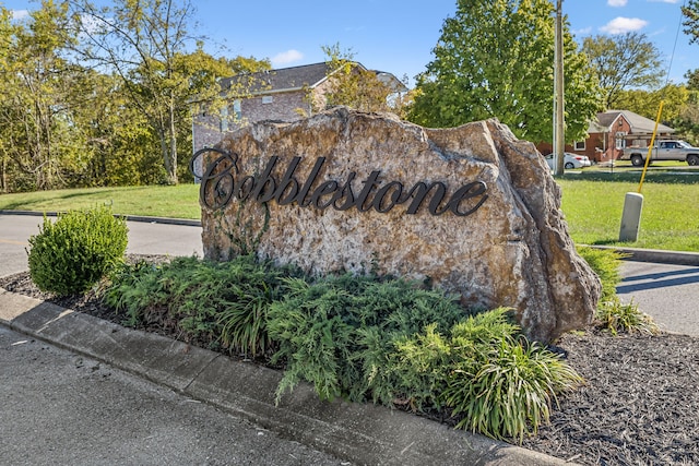 community sign featuring a lawn