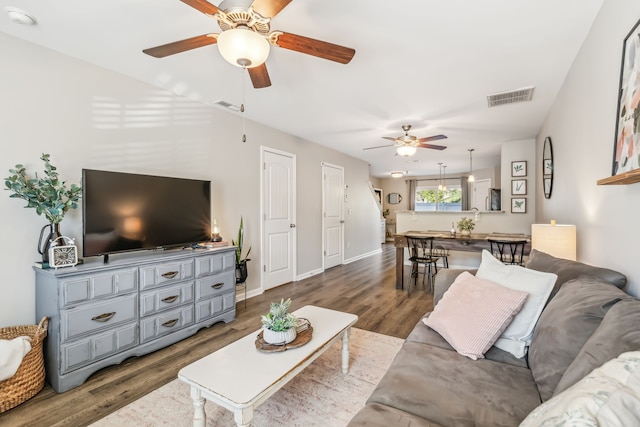 living room with ceiling fan and hardwood / wood-style flooring