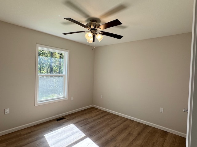 spare room with ceiling fan and hardwood / wood-style flooring