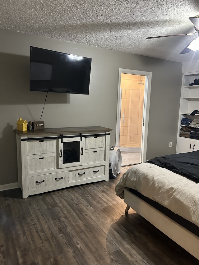 bedroom featuring ceiling fan, dark hardwood / wood-style floors, a textured ceiling, and ensuite bath