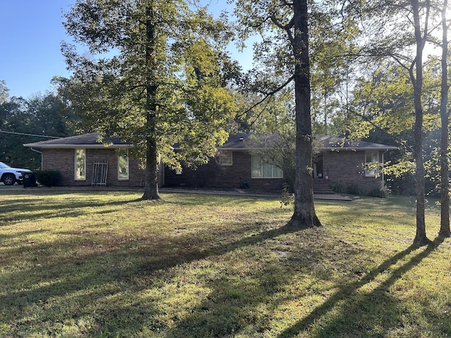 841 Asbury Dr, New Johnsonville, TN 37134 - view of front facade with a front lawn and brick siding
