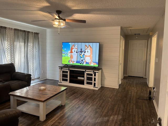 841 Asbury Dr, New Johnsonville, TN 37134 - living area with attic access, ceiling fan, a textured ceiling, dark wood-style floors, and baseboards