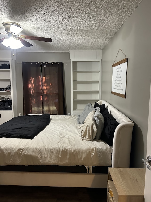 bedroom with ceiling fan and a textured ceiling