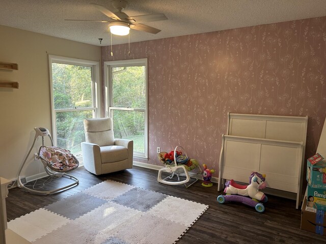841 Asbury Dr, New Johnsonville, TN 37134 - sitting room featuring wallpapered walls, wood finished floors, ceiling fan, baseboards, and a textured ceiling