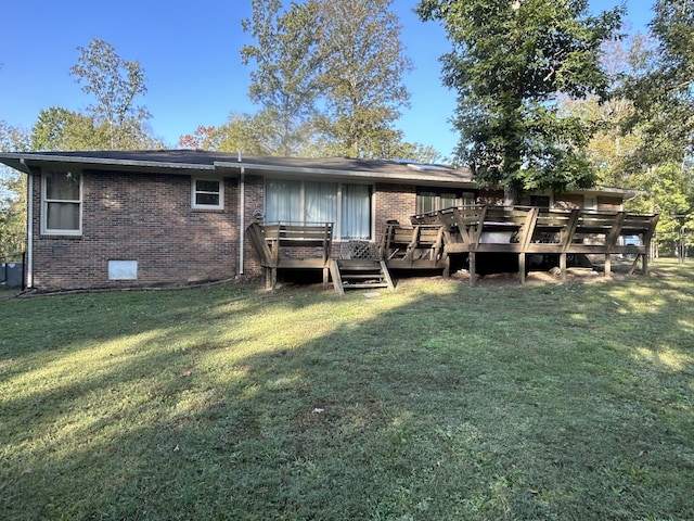 rear view of house with a yard and a deck