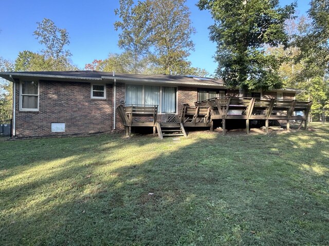 841 Asbury Dr, New Johnsonville, TN 37134 - rear view of property featuring brick siding, a lawn, a wooden deck, and crawl space