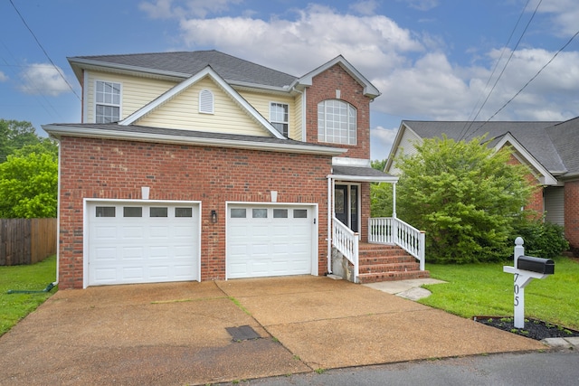 view of property with a garage and a front yard