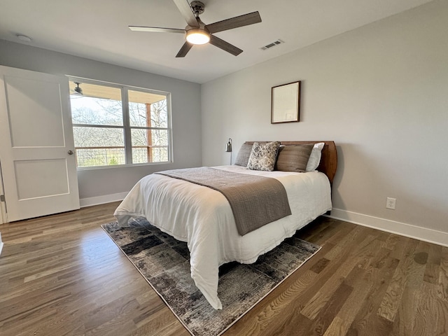 bedroom with ceiling fan and dark wood-type flooring