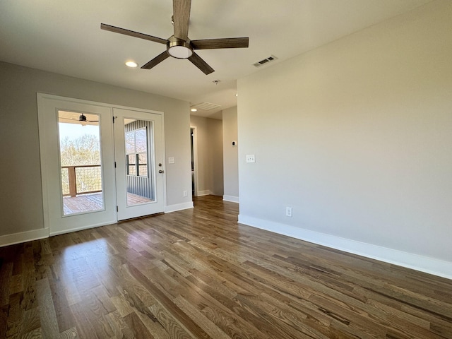 empty room with ceiling fan and dark hardwood / wood-style floors