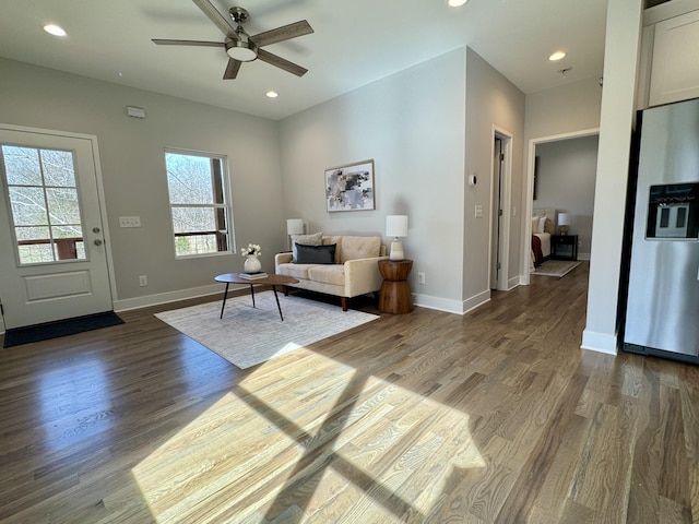 living room with ceiling fan and dark hardwood / wood-style flooring