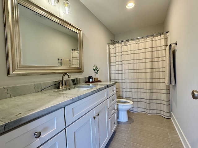 bathroom featuring vanity, toilet, and tile patterned floors