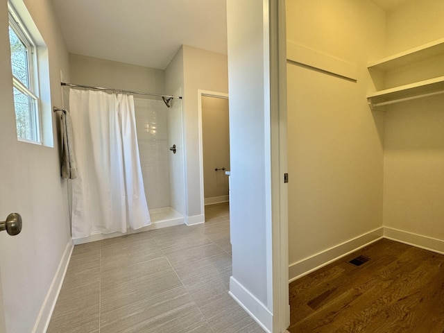 bathroom featuring a shower with curtain and wood-type flooring