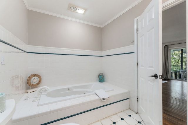 bathroom with crown molding, a relaxing tiled tub, and wood-type flooring