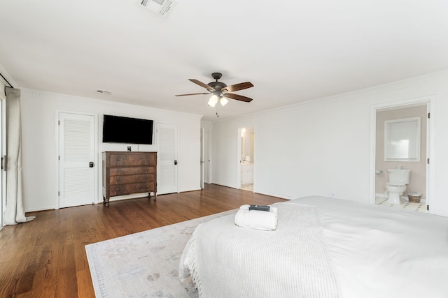 bedroom featuring crown molding, connected bathroom, dark hardwood / wood-style flooring, and ceiling fan