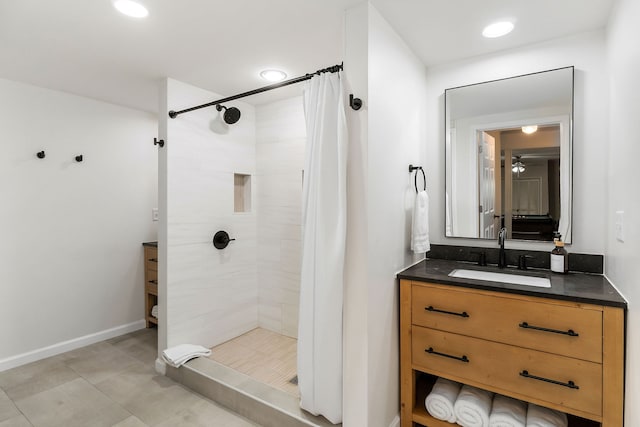 bathroom with walk in shower, tile patterned floors, and vanity