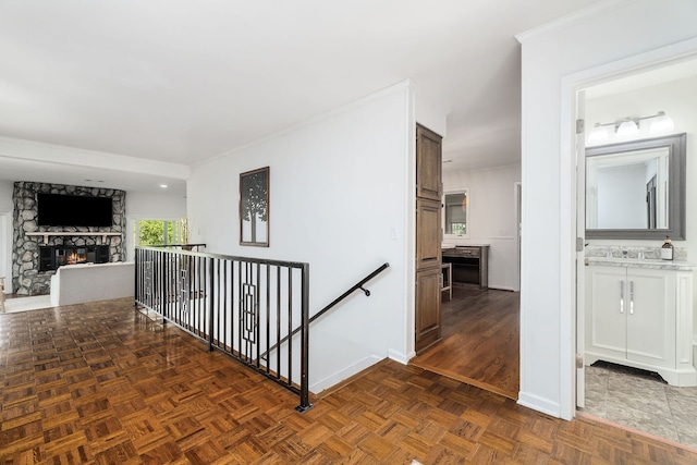 hallway featuring dark parquet floors and sink