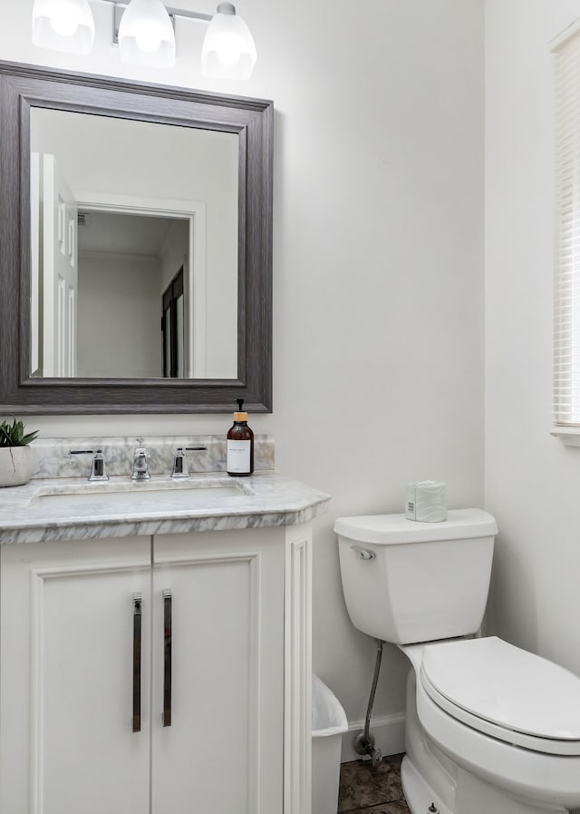 bathroom featuring vanity and toilet