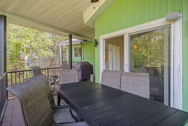 wooden deck featuring a grill