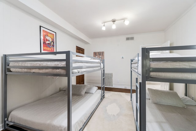 bedroom featuring crown molding and hardwood / wood-style flooring